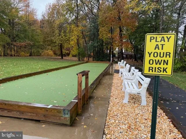 a green field with trees in the background