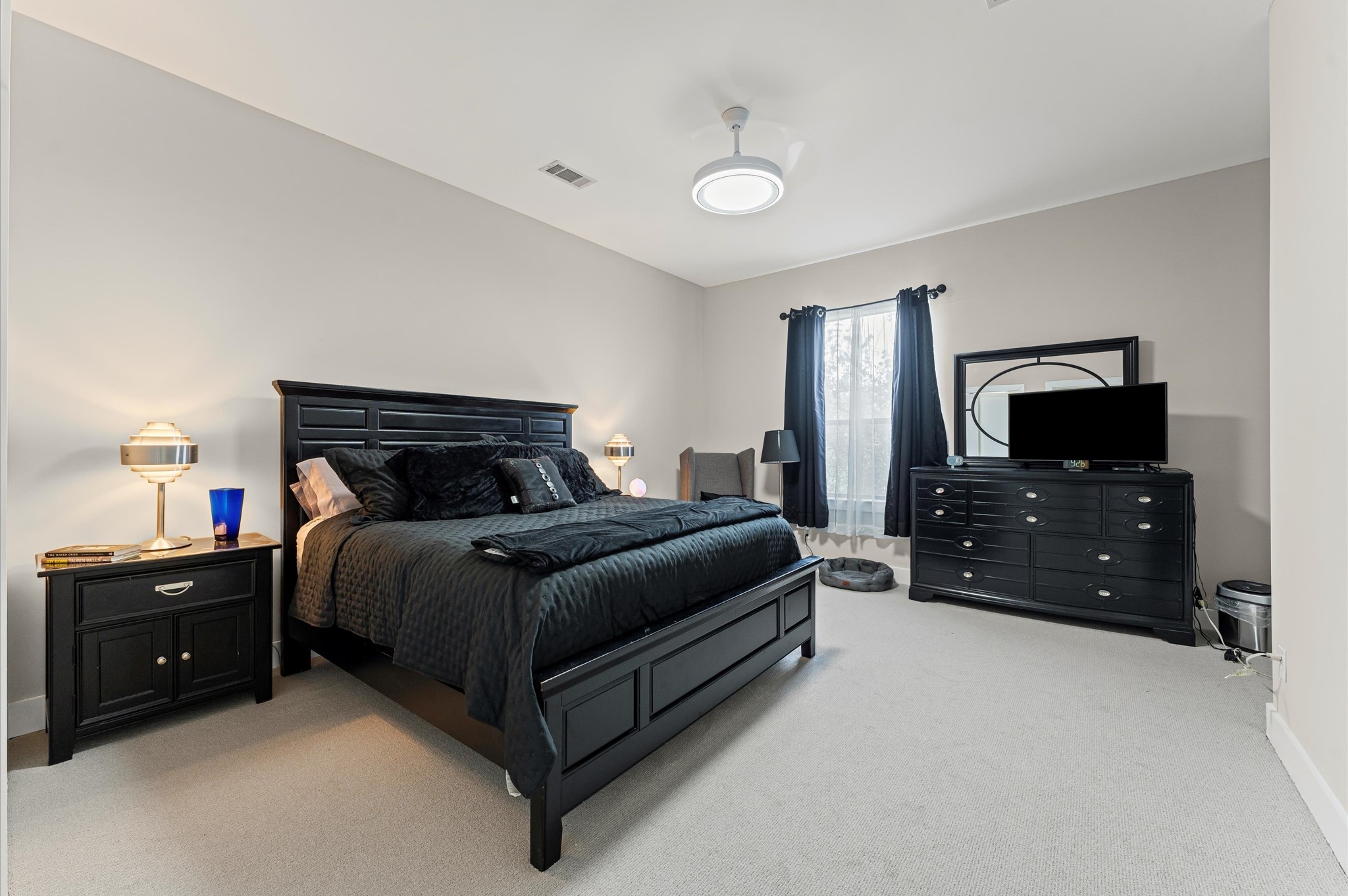 730 Ruthven Street Houston, TX 77019 - Photo 18 of 36 a bedroom with a bed and a tv on dresser