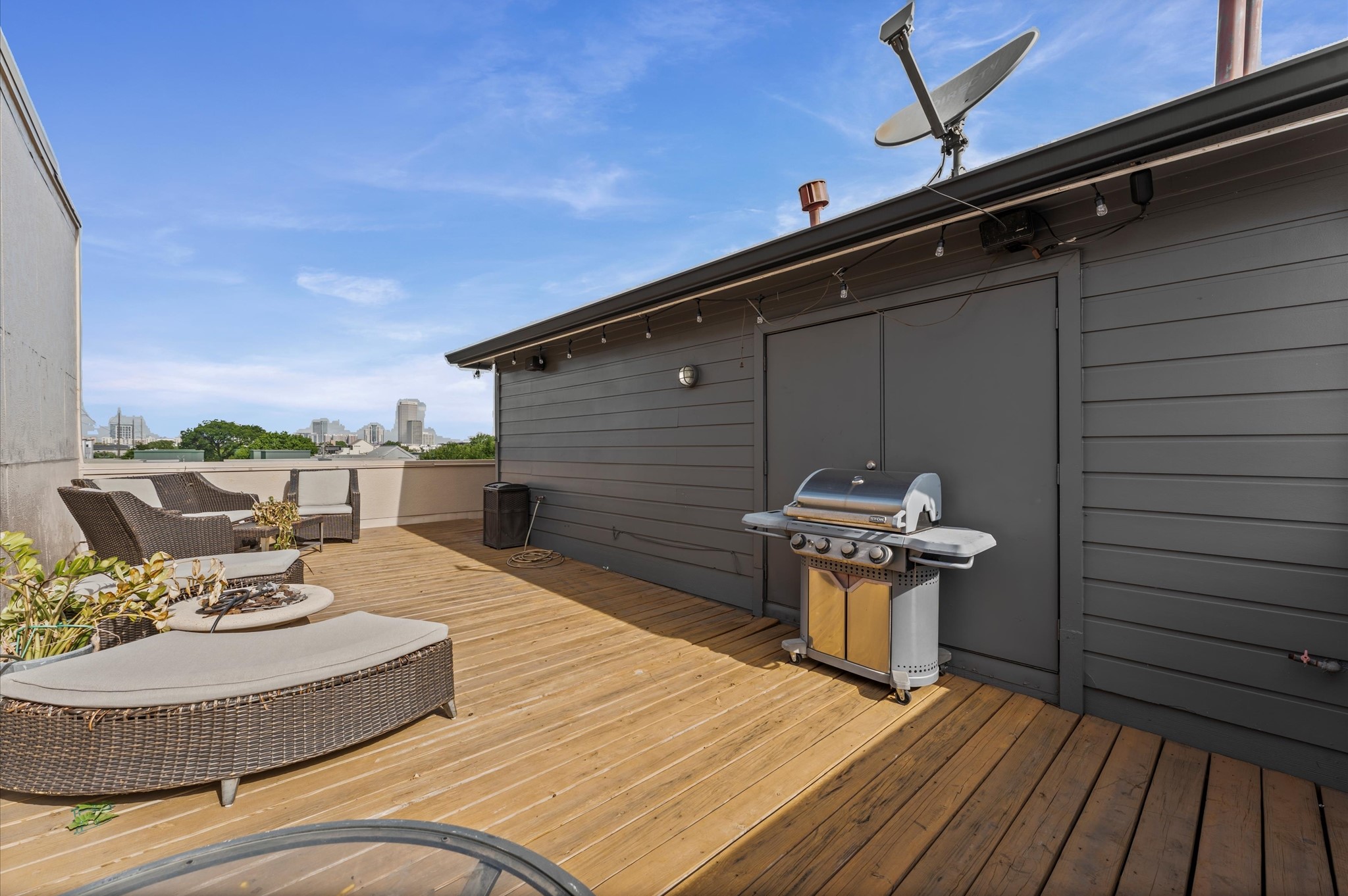 730 Ruthven Street Houston, TX 77019 - Photo 24 of 36 a roof deck with a table and chairs and potted plants