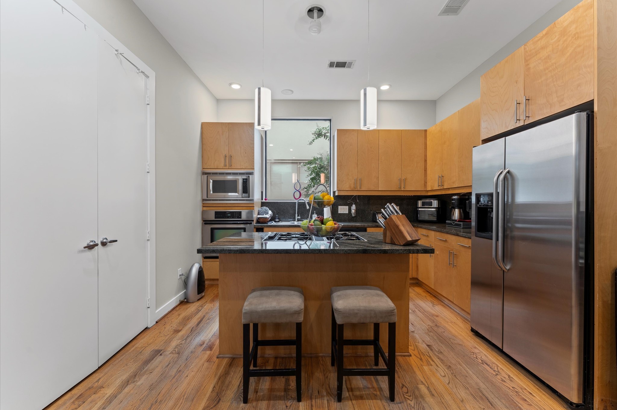 730 Ruthven Street Houston, TX 77019 - Photo 7 of 36 a kitchen with refrigerator and chairs