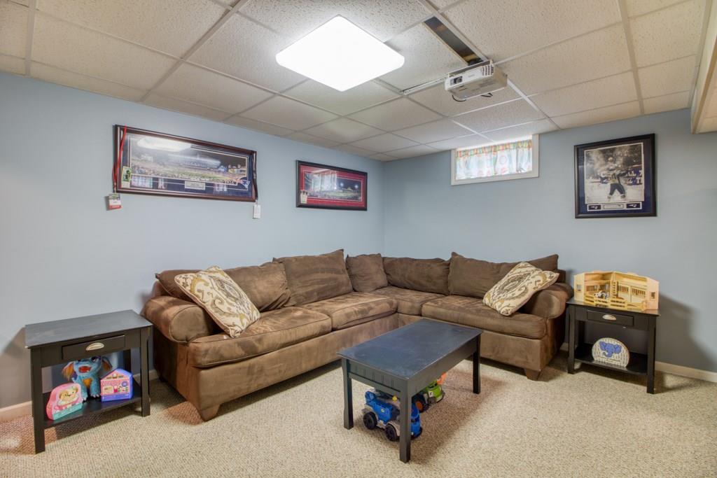 129 Amostown Road West Springfield, MA 01089 - Photo 19 of 25 a living room with furniture a couch and a wall painting