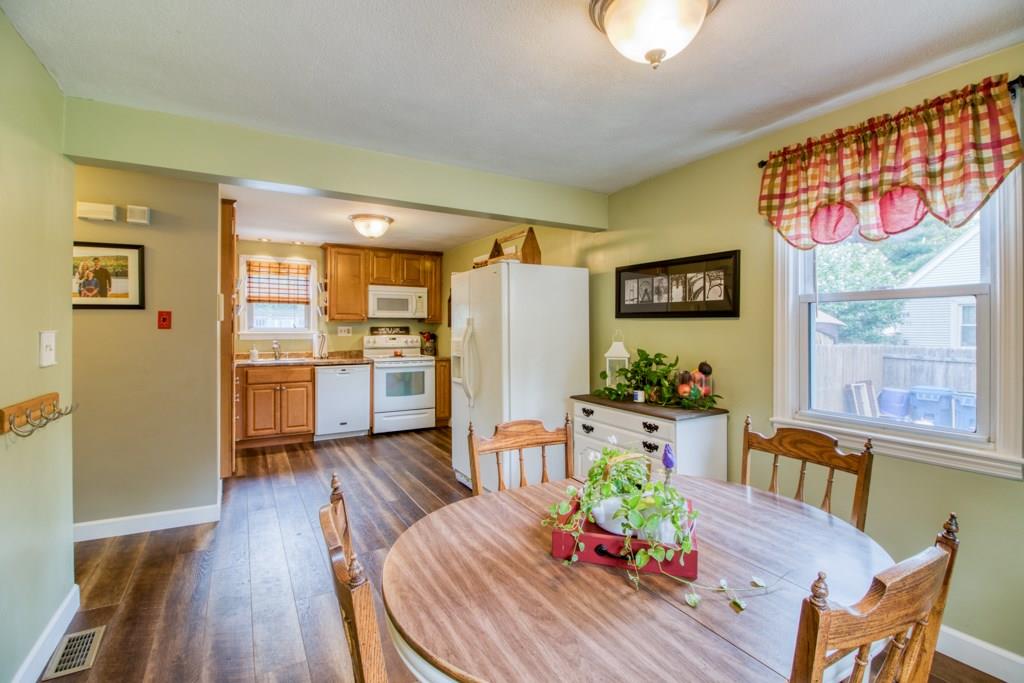 129 Amostown Road West Springfield, MA 01089 - Photo 6 of 25 a living room with furniture dining table wooden floor and a large window