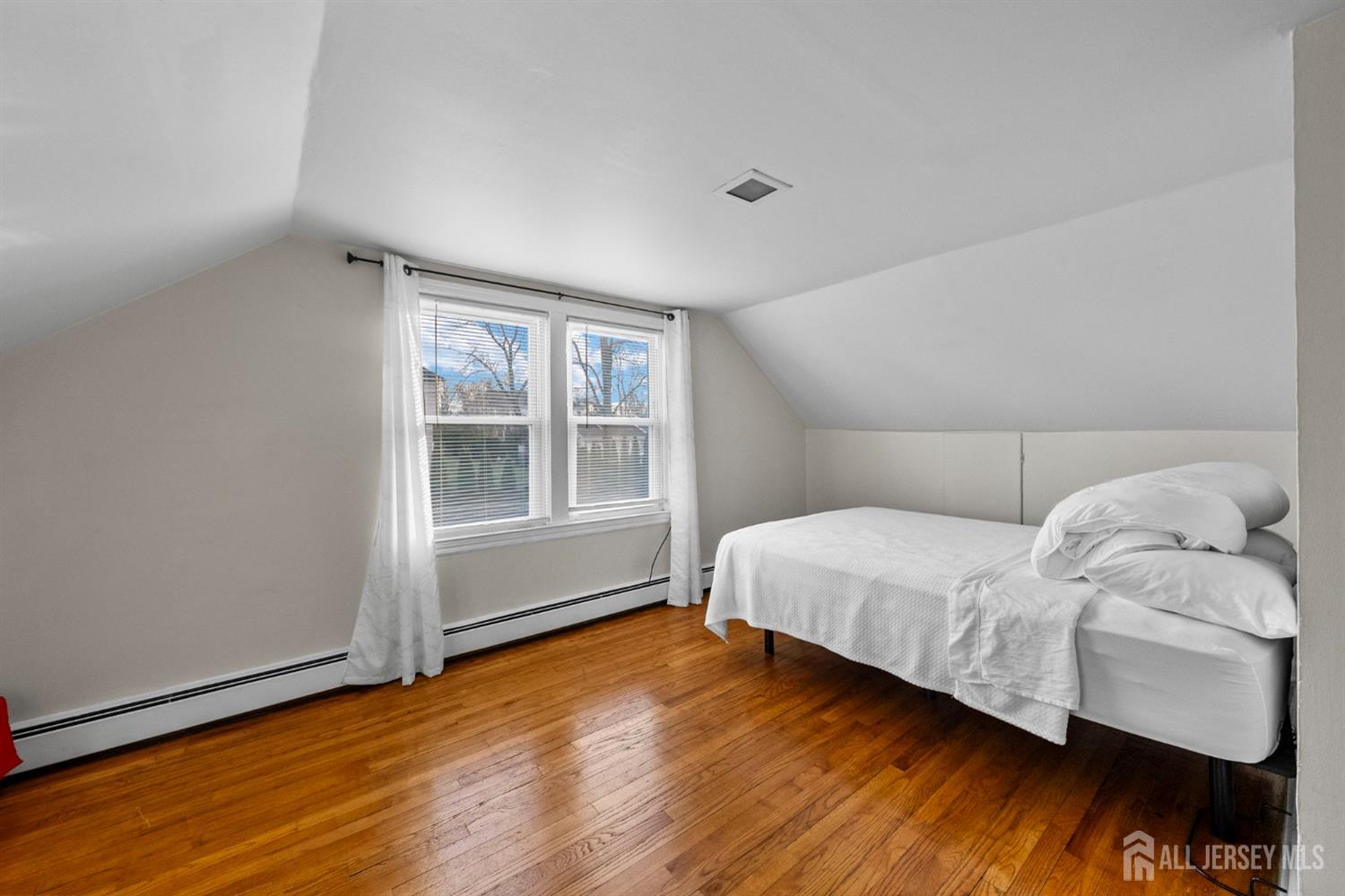 973 Ellis Parkway Edison, NJ 08820 - Photo 11 of 34 a bedroom with a bed and wooden floor