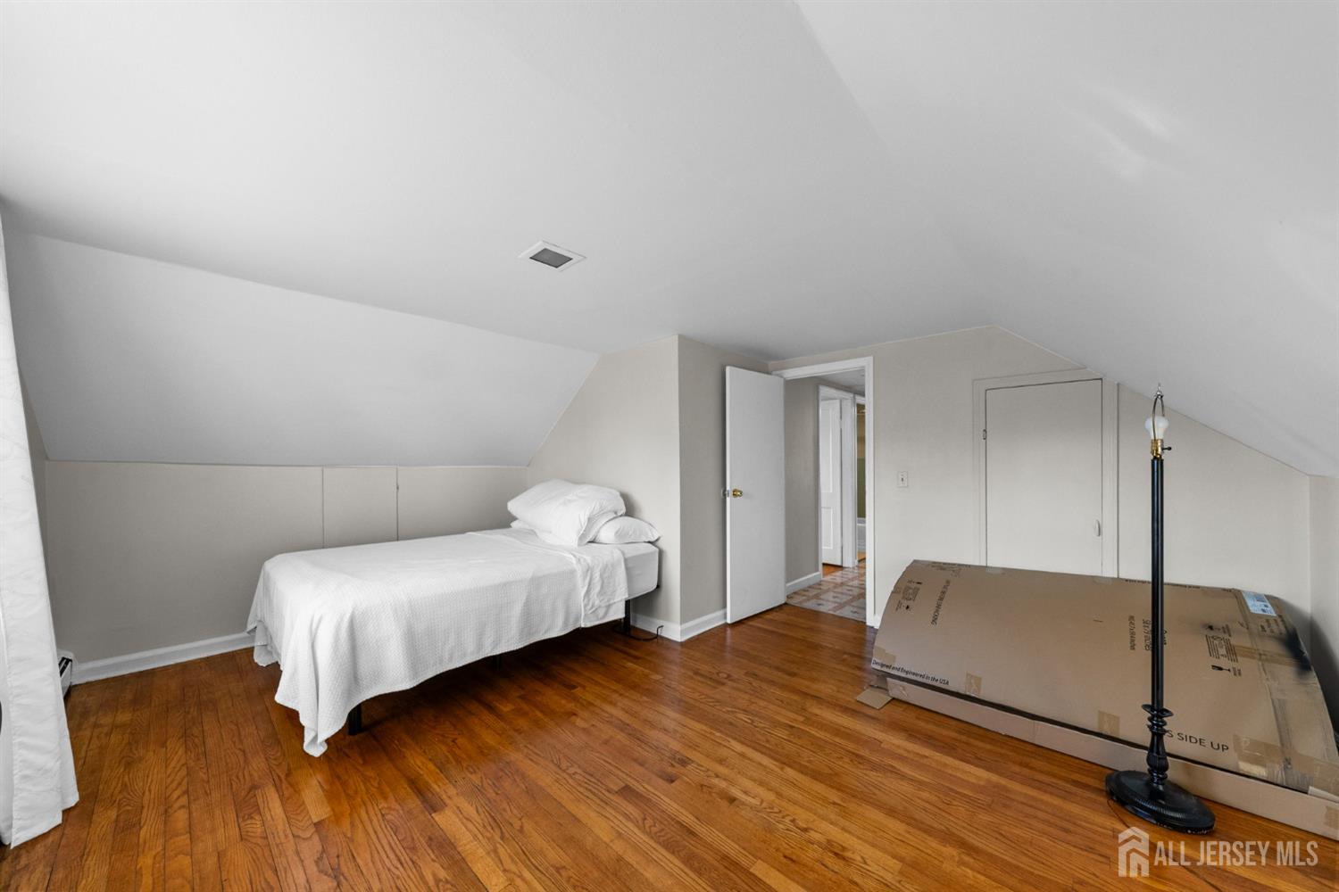 973 Ellis Parkway Edison, NJ 08820 - Photo 12 of 34 a bedroom with a bed and wooden floor