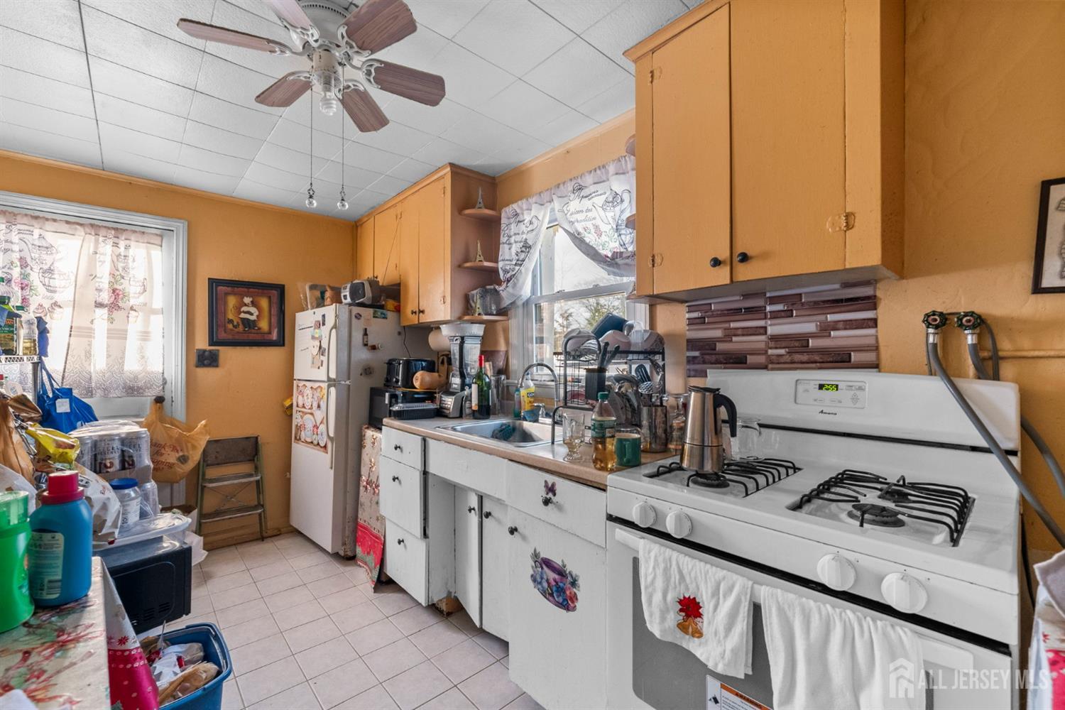 973 Ellis Parkway Edison, NJ 08820 - Photo 20 of 34 a kitchen with a stove and a refrigerator