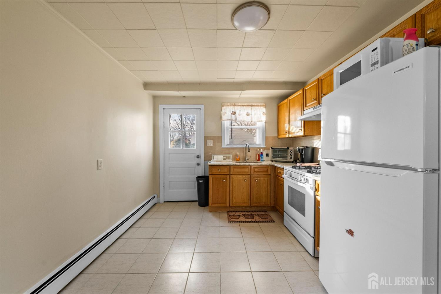 973 Ellis Parkway Edison, NJ 08820 - Photo 26 of 34 a kitchen with a refrigerator a stove top oven and a window