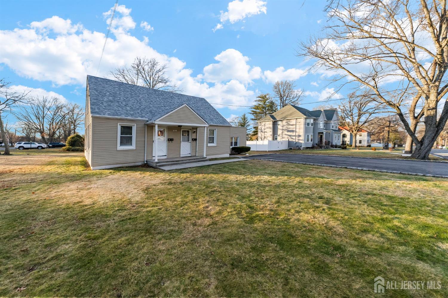 973 Ellis Parkway Edison, NJ 08820 - Photo 31 of 34 a front view of a house with a big yard and large trees