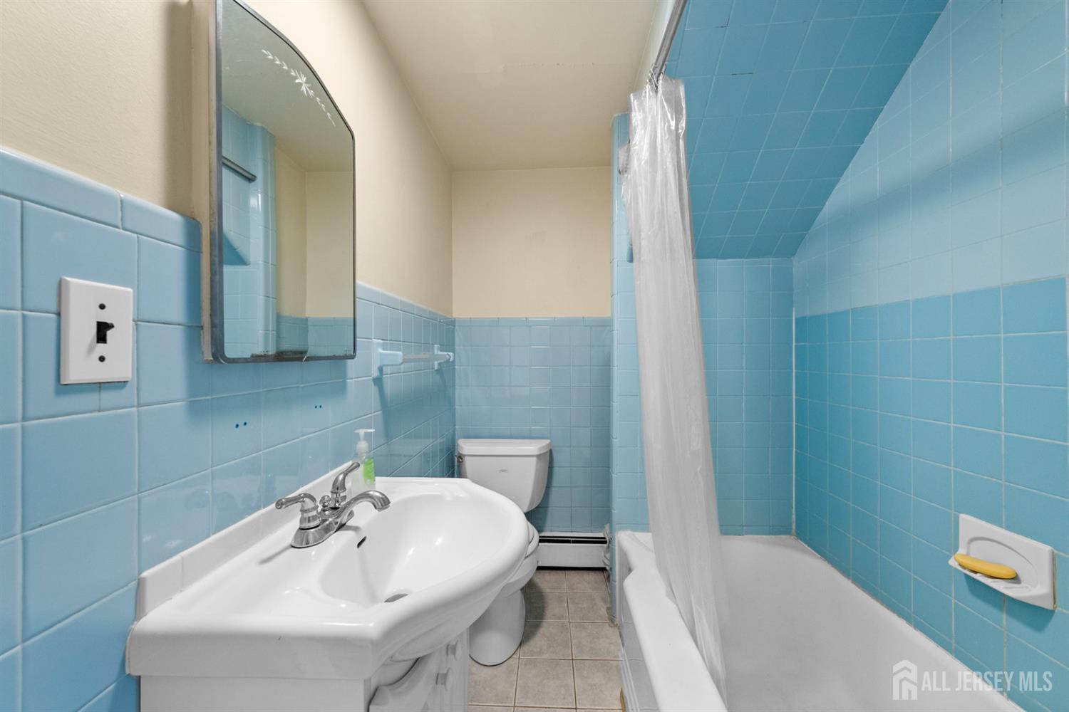 973 Ellis Parkway Edison, NJ 08820 - Photo 4 of 34 a bathroom with a sink a toilet and shower