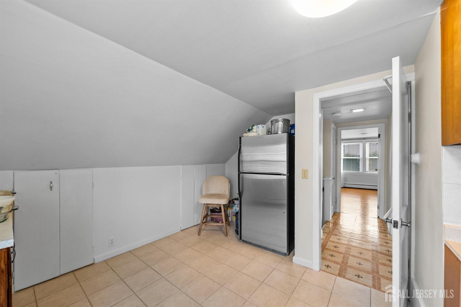 973 Ellis Parkway Edison, NJ 08820 - Photo 6 of 34 a view of a refrigerator in kitchen and an empty room
