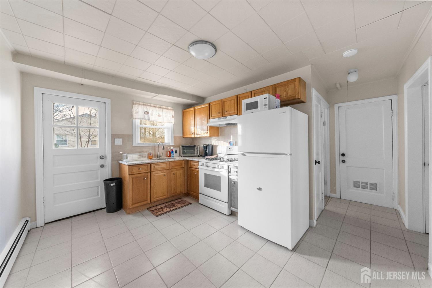 973 Ellis Parkway Edison, NJ 08820 - Photo 7 of 34 a kitchen with cabinets and white appliances