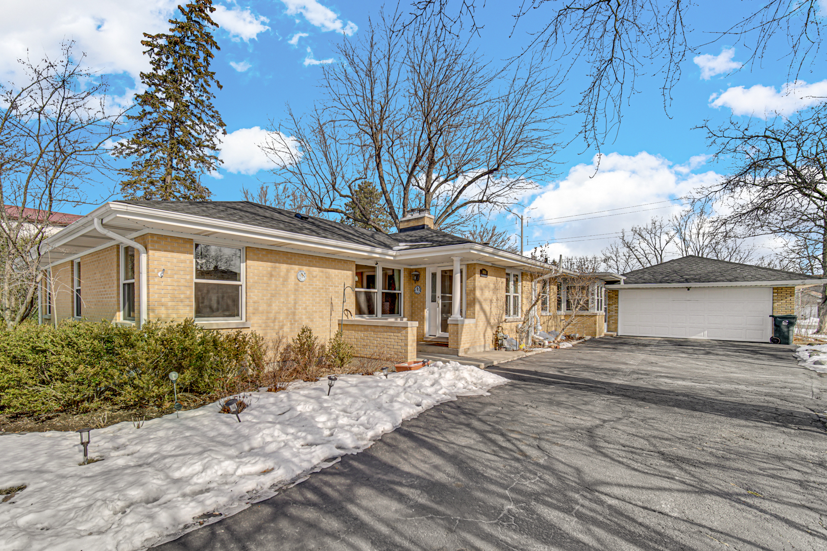1855 North Happ Road Northbrook, IL 60062 - Photo 1 of 32 a front view of a house with a yard and outdoor seating