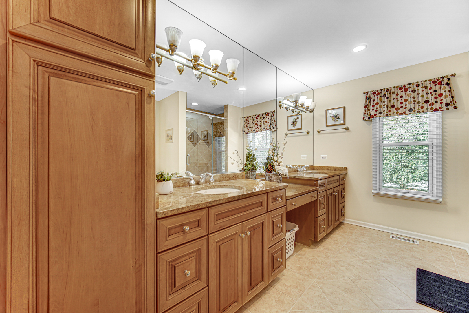 1855 North Happ Road Northbrook, IL 60062 - Photo 20 of 32 a bathroom with a granite countertop sink a toilet a mirror and shower