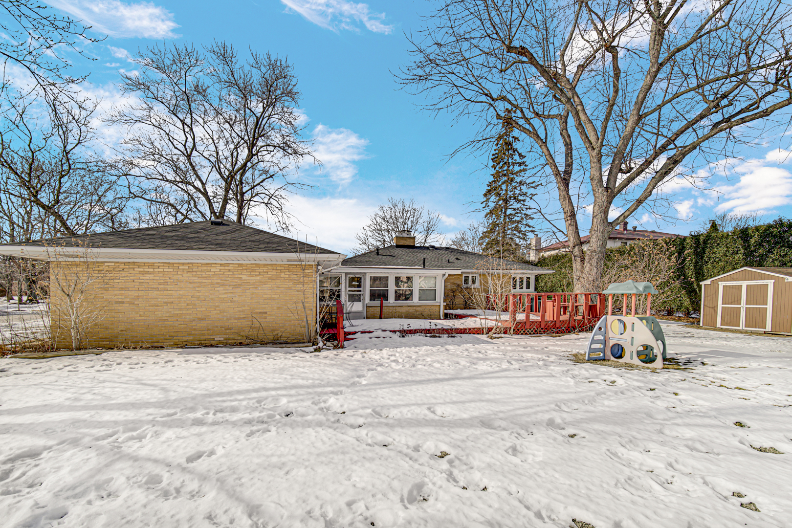1855 North Happ Road Northbrook, IL 60062 - Photo 29 of 32 a view of a house with a yard covered in snow