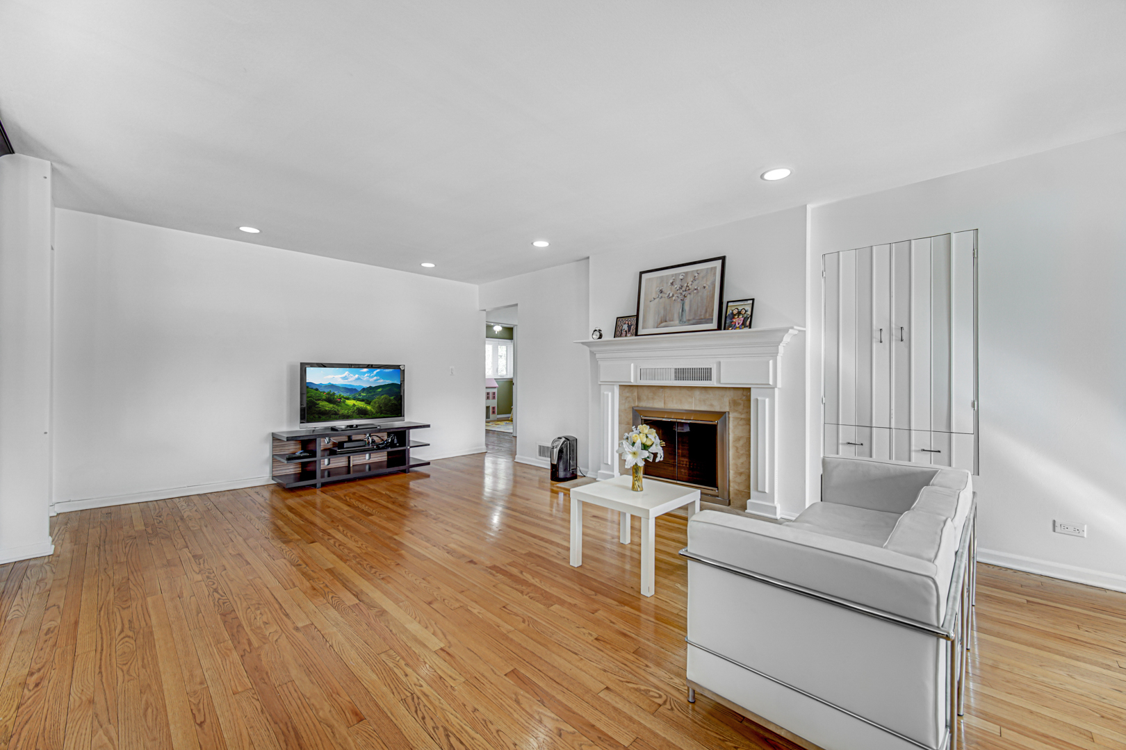 1855 North Happ Road Northbrook, IL 60062 - Photo 5 of 32 a living room with furniture a fireplace and a flat screen tv