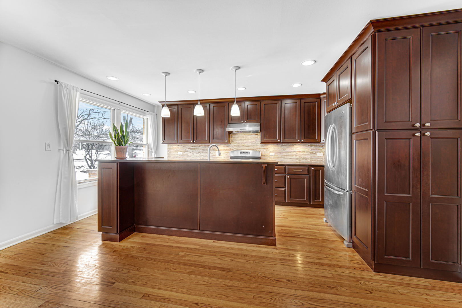 1855 North Happ Road Northbrook, IL 60062 - Photo 10 of 32 a kitchen with stainless steel appliances granite countertop a refrigerator a sink and wooden cabinets