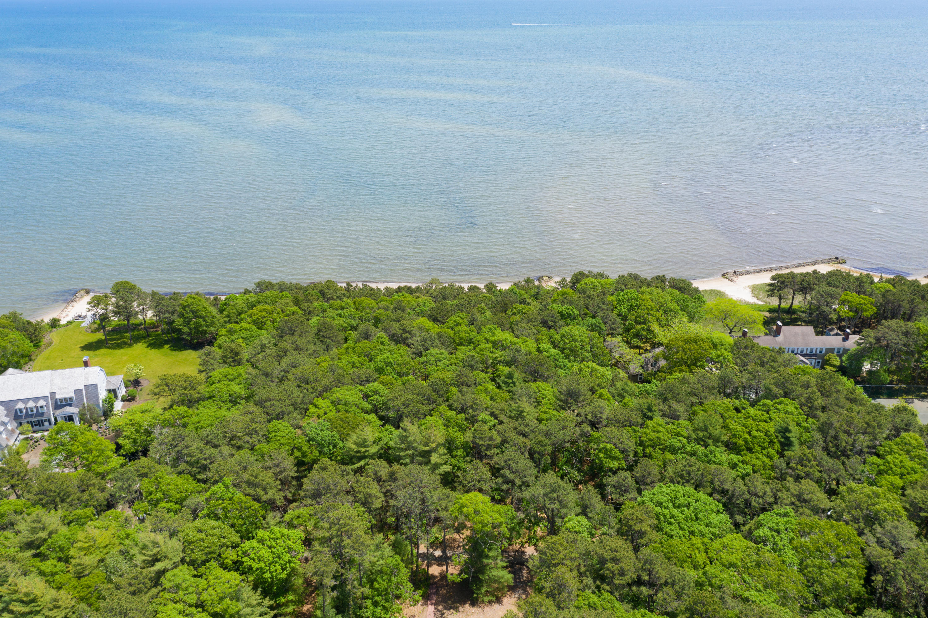 180 Vineyard Road Cotuit, MA 02635 - Photo 10 of 13 a backyard of a house with lots of green space and garden in back