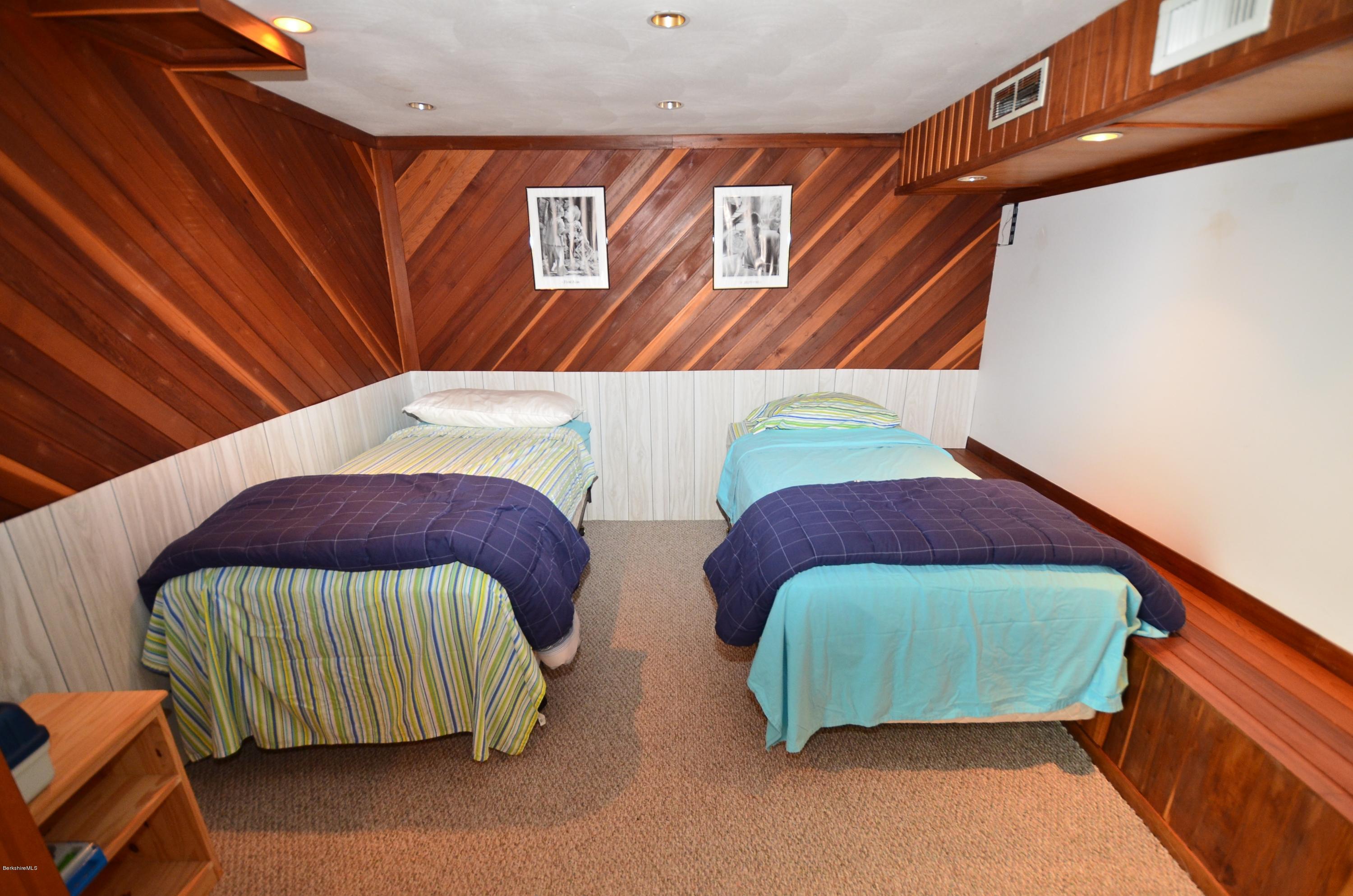 996 Reservoir Road Otis, MA 01029 - Photo 13 of 23 a bedroom with two beds and a painting on the wall