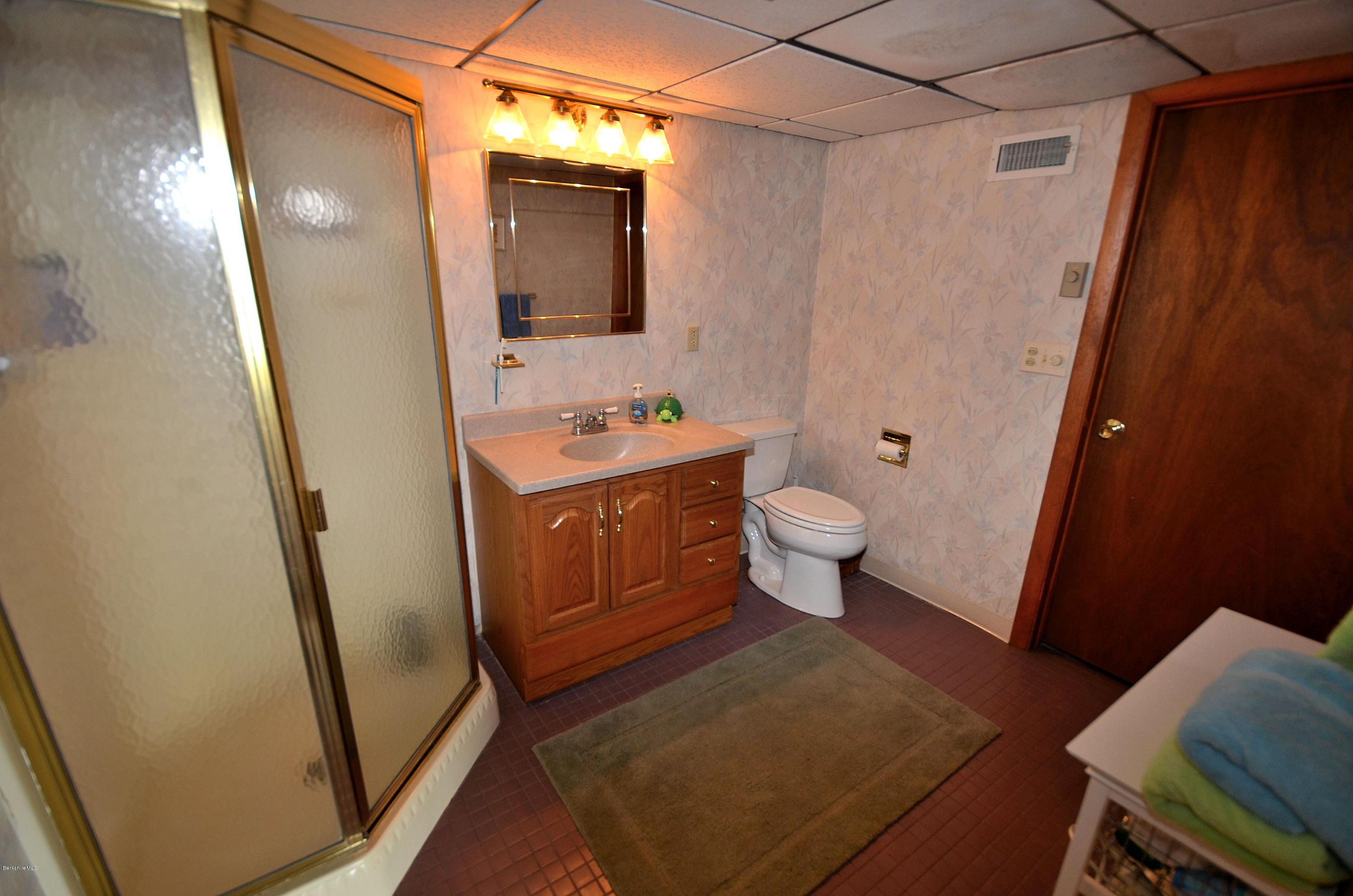 996 Reservoir Road Otis, MA 01029 - Photo 14 of 23 a bathroom with a sink a toilet a mirror and shower