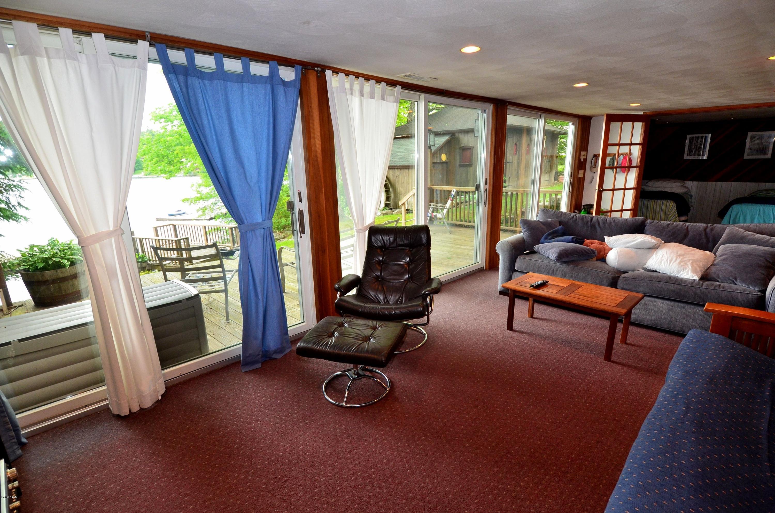 996 Reservoir Road Otis, MA 01029 - Photo 16 of 23 a living room with furniture and a fireplace