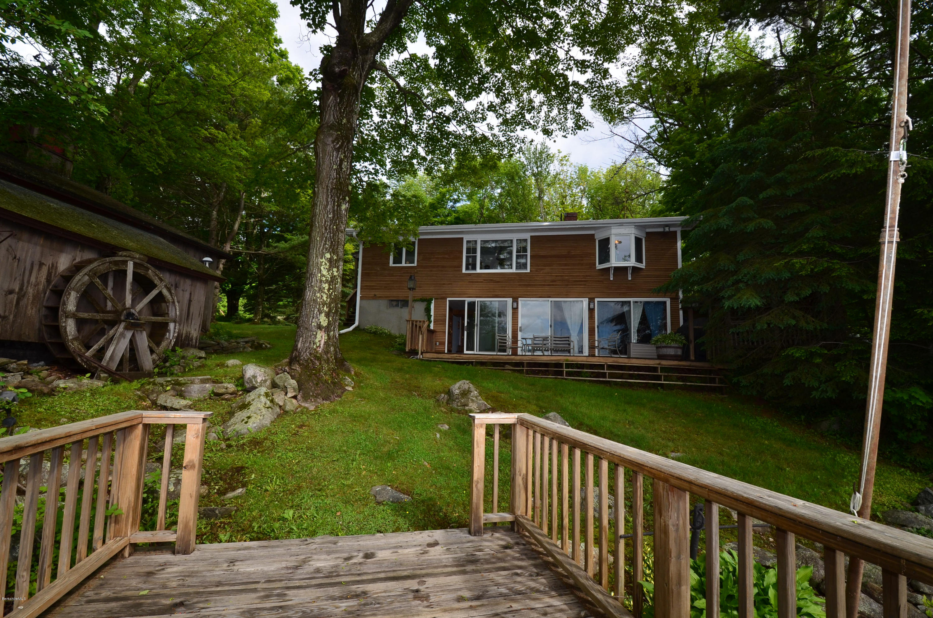 996 Reservoir Road Otis, MA 01029 - Photo 17 of 23 a view of a house with backyard and sitting area