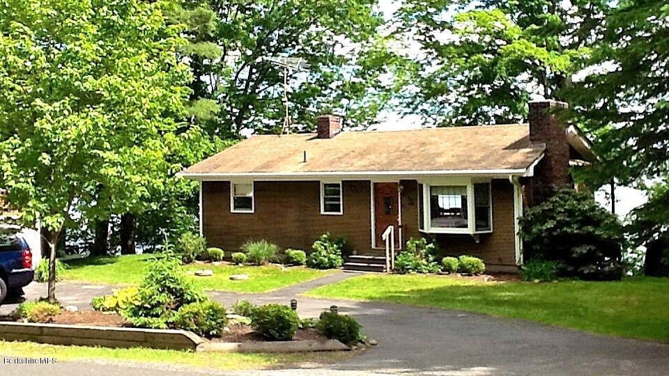 996 Reservoir Road Otis, MA 01029 - Photo 21 of 23 a front view of a house with a garden