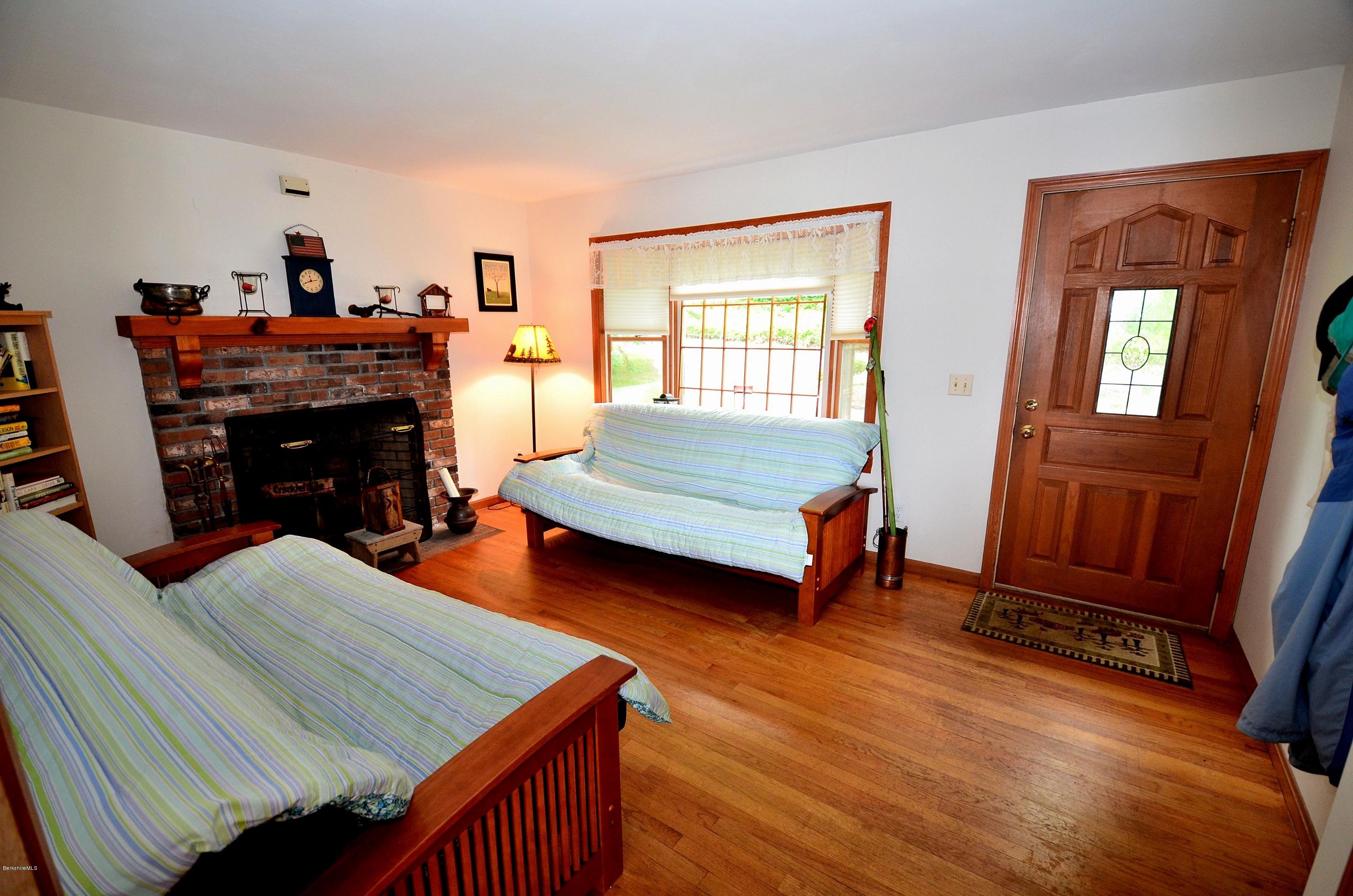 996 Reservoir Road Otis, MA 01029 - Photo 9 of 23 a living room with furniture and a fireplace