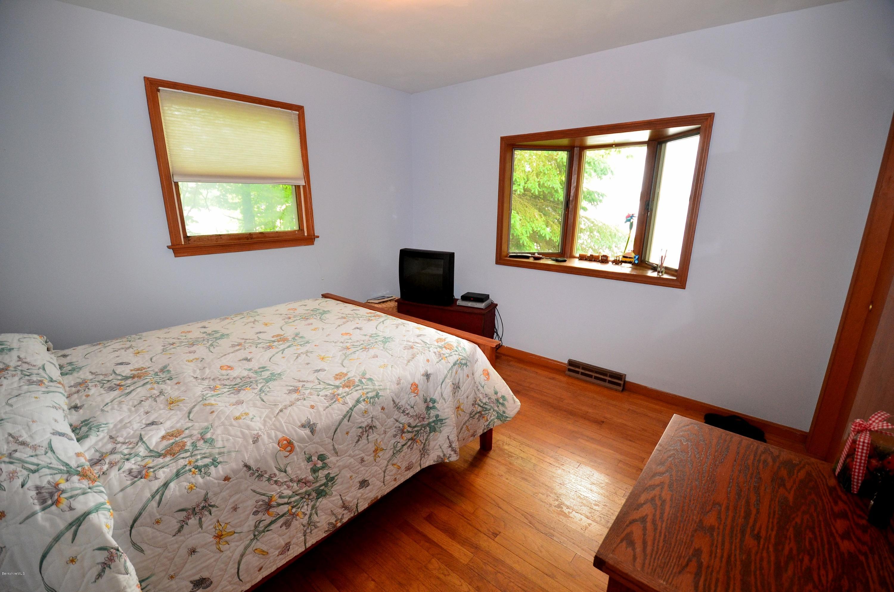 996 Reservoir Road Otis, MA 01029 - Photo 10 of 23 a bedroom with a bed and a window