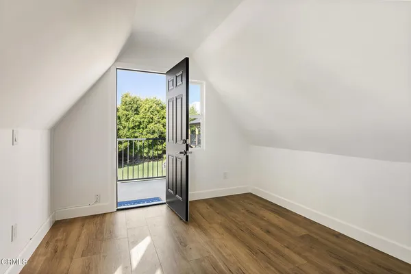 a view of a kitchen with wooden floor and electronic appliances
