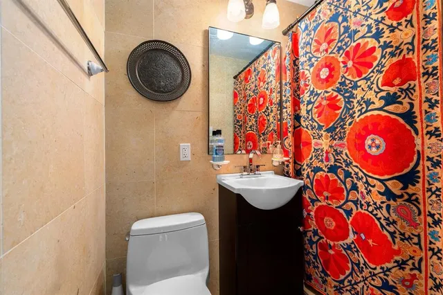 a bedroom with a bed dresser and a flat tv screen