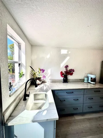 a view of a patio with table and chairs under an umbrella