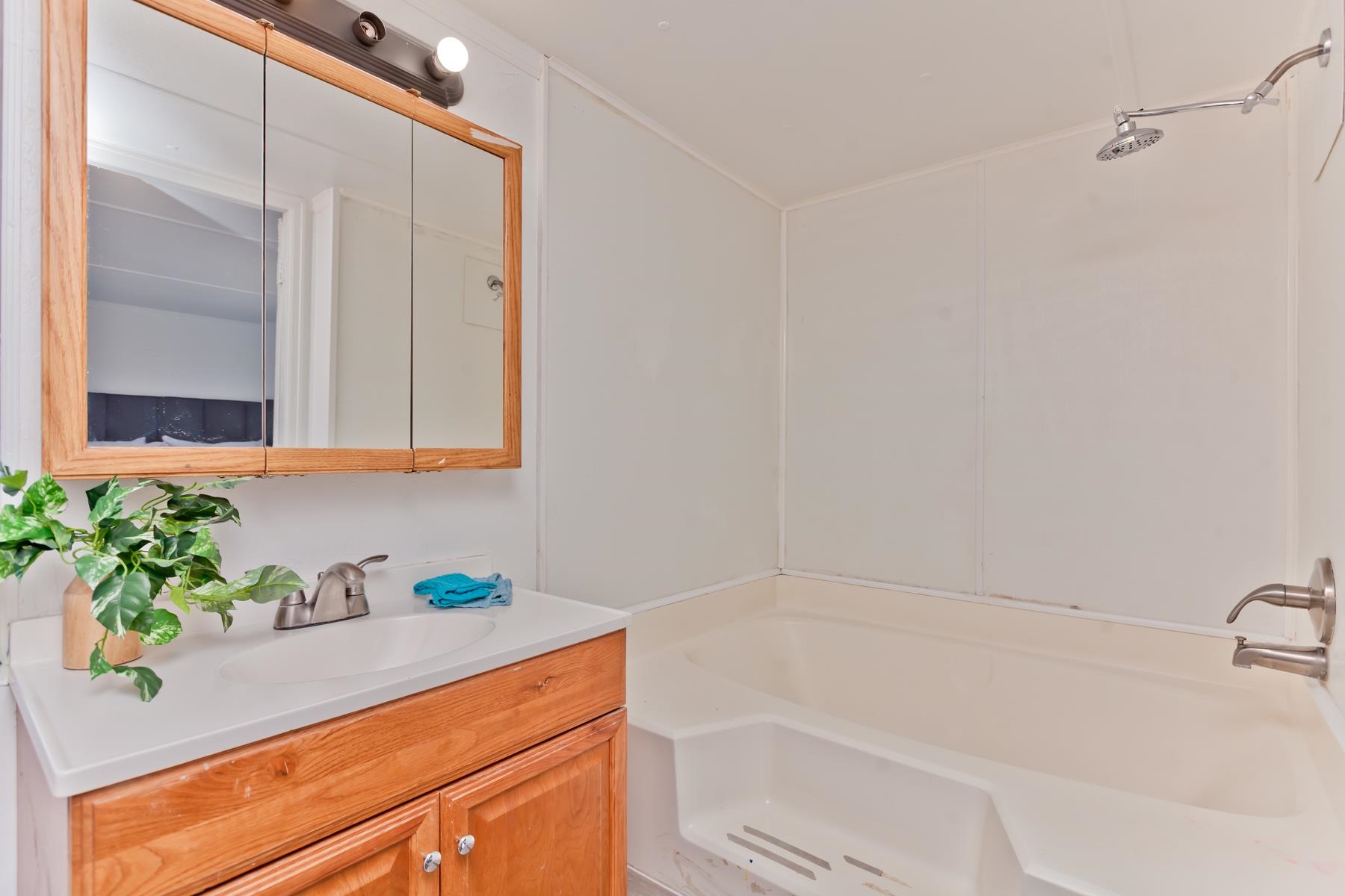 432 Pisces Circle Fruita, CO 81521 - Photo 20 of 40 a bathroom with a granite countertop sink a mirror and shower