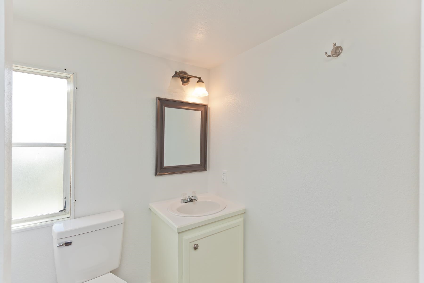 432 Pisces Circle Fruita, CO 81521 - Photo 29 of 40 a bathroom with a toilet sink and mirror