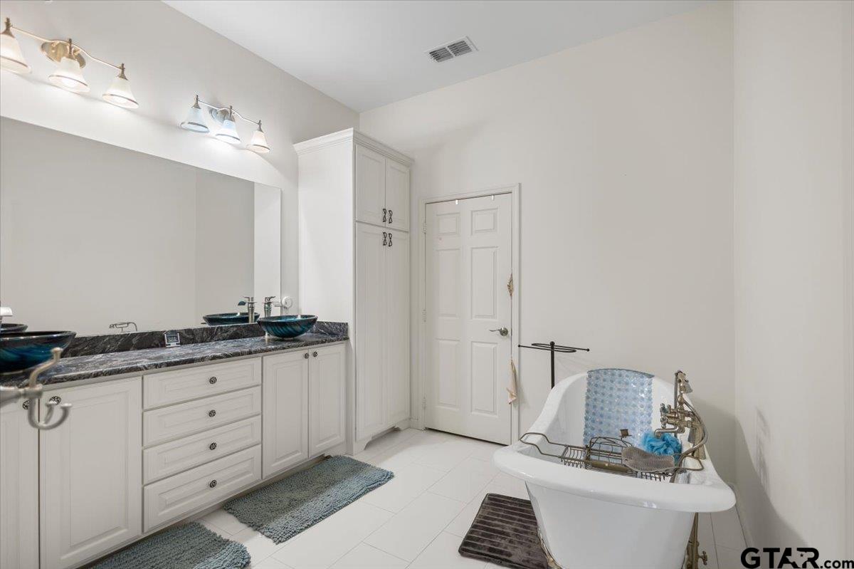 15515 County Road 434 Lindale, TX 75771 - Photo 18 of 46 a bathroom with a granite countertop sink and a mirror
