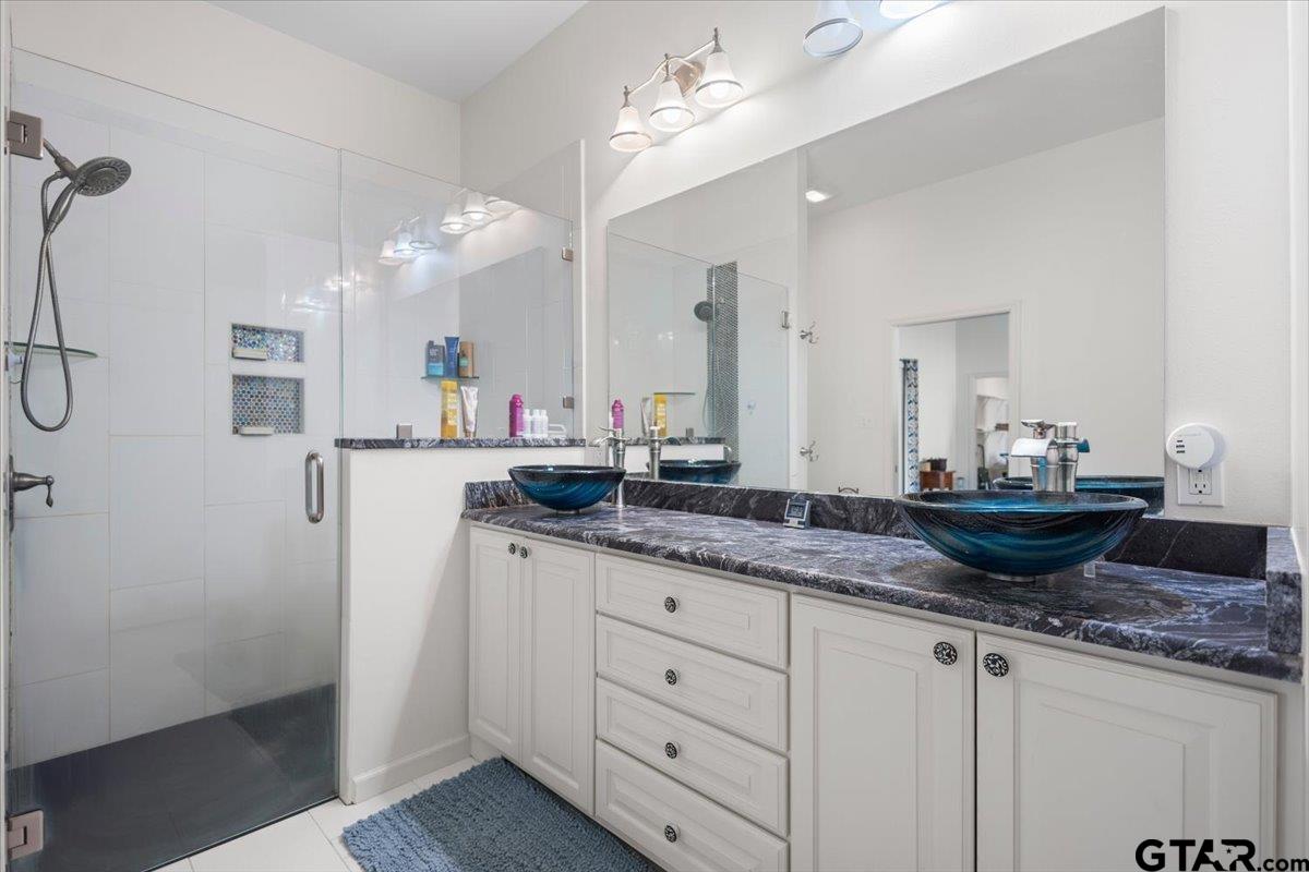 15515 County Road 434 Lindale, TX 75771 - Photo 19 of 46 a bathroom with a granite countertop sink and a mirror