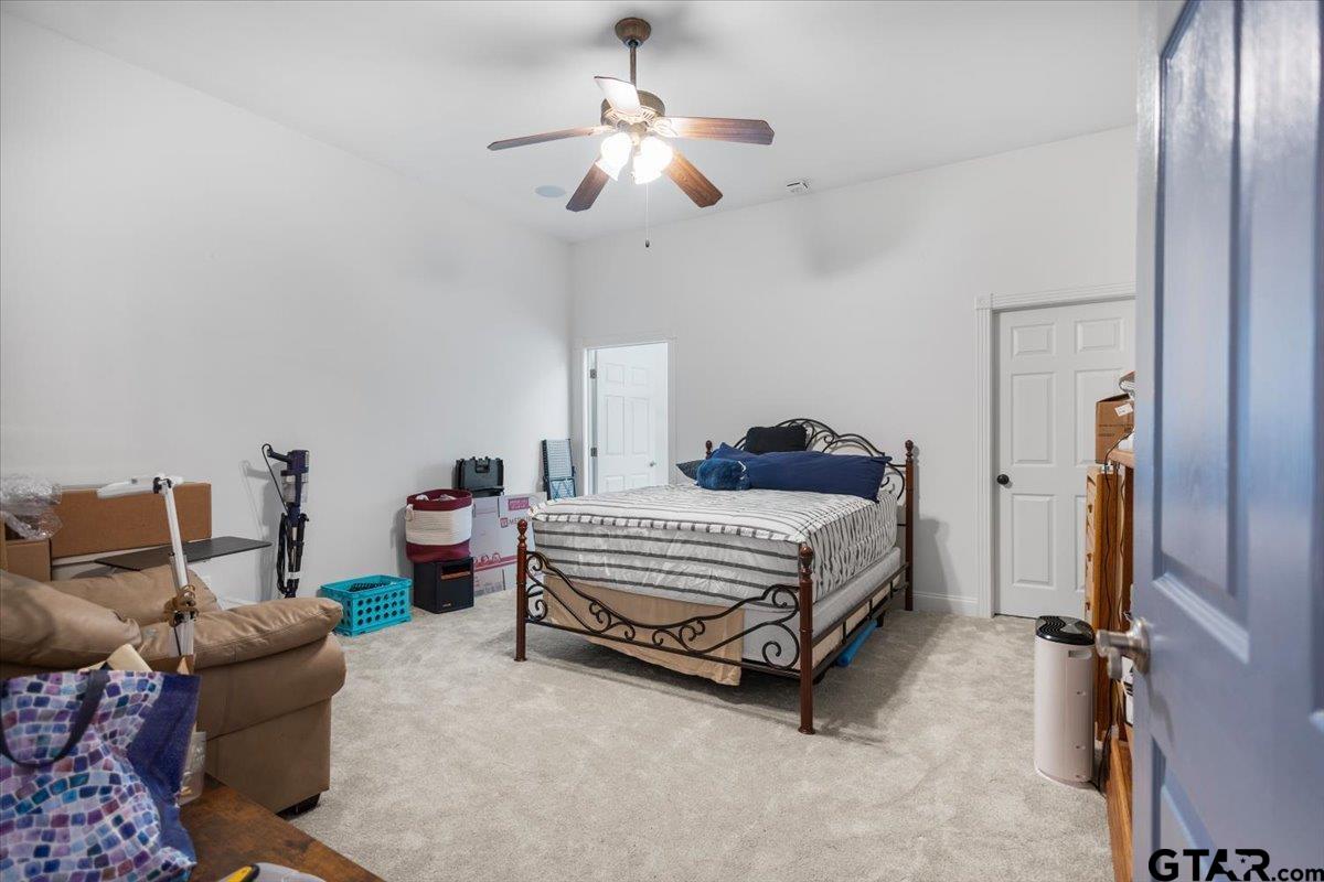 15515 County Road 434 Lindale, TX 75771 - Photo 26 of 46 a bedroom with bed and a chandelier