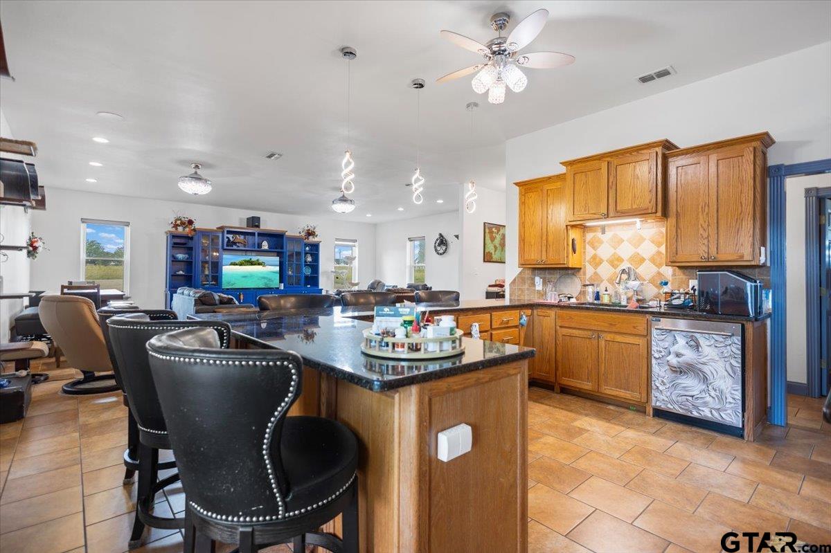 15515 County Road 434 Lindale, TX 75771 - Photo 7 of 46 a kitchen with kitchen island a dining table and chairs