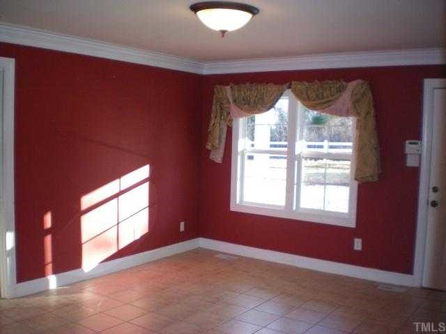 604 Olin Road Cedar Grove, NC 27231 - Photo 3 of 7 Bright, open Living Room with tile flooring and window treatments that convey!