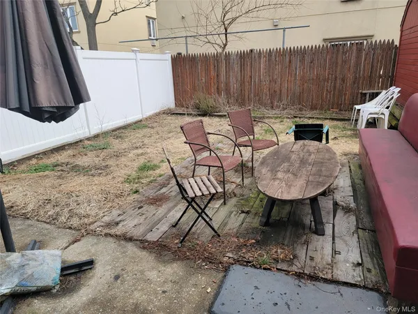 a backyard of a house with table and chairs