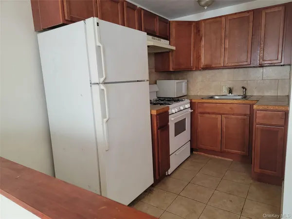 a white refrigerator freezer sitting in a kitchen