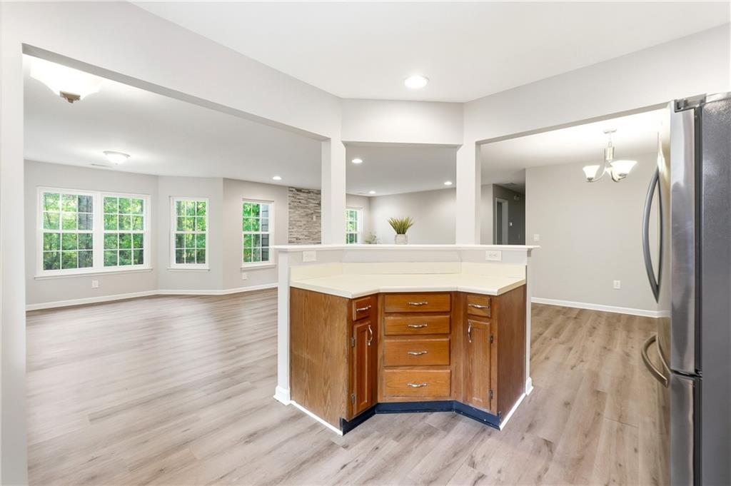 604 Mill Pond Road, Unit 604 Roswell, GA 30076 - Photo 11 of 28 a view of kitchen with granite countertop cabinets and wooden floor