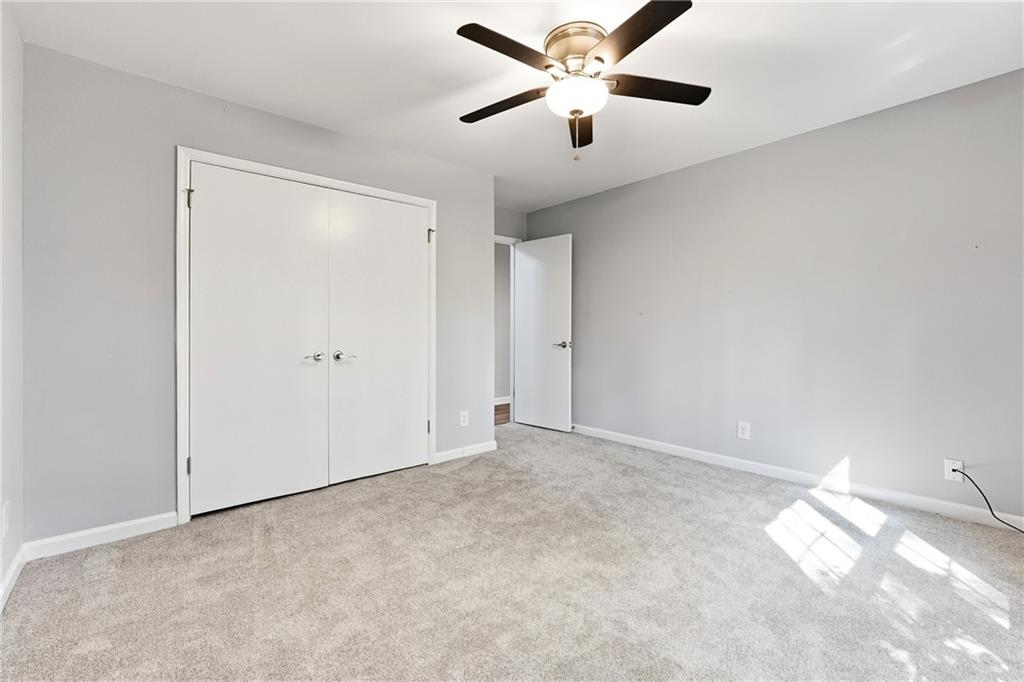 604 Mill Pond Road, Unit 604 Roswell, GA 30076 - Photo 13 of 28 an empty room with chandelier fan