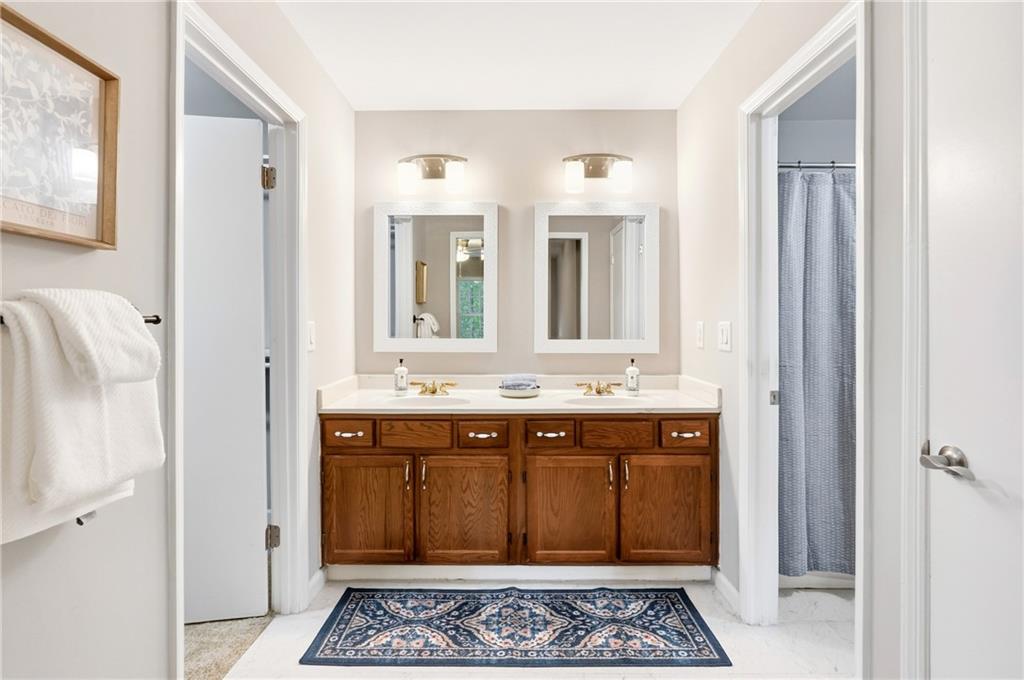 604 Mill Pond Road, Unit 604 Roswell, GA 30076 - Photo 17 of 28 a bathroom with a sink and a mirror