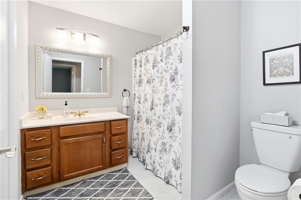 604 Mill Pond Road, Unit 604 Roswell, GA 30076 - Photo 20 of 28 a bathroom with a toilet sink and mirror