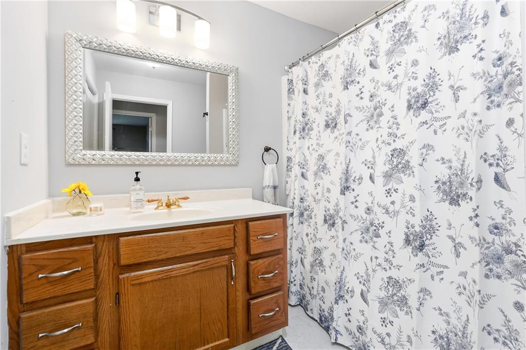 604 Mill Pond Road, Unit 604 Roswell, GA 30076 - Photo 21 of 28 a bathroom with a sink and a mirror