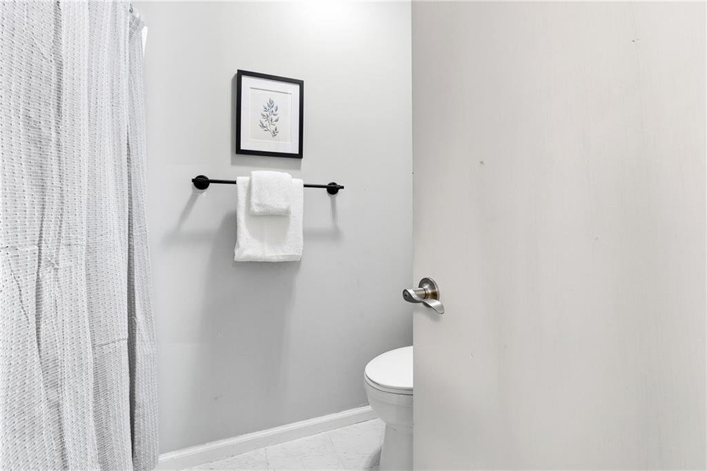 604 Mill Pond Road, Unit 604 Roswell, GA 30076 - Photo 22 of 28 a white toilet sitting next to a white sink