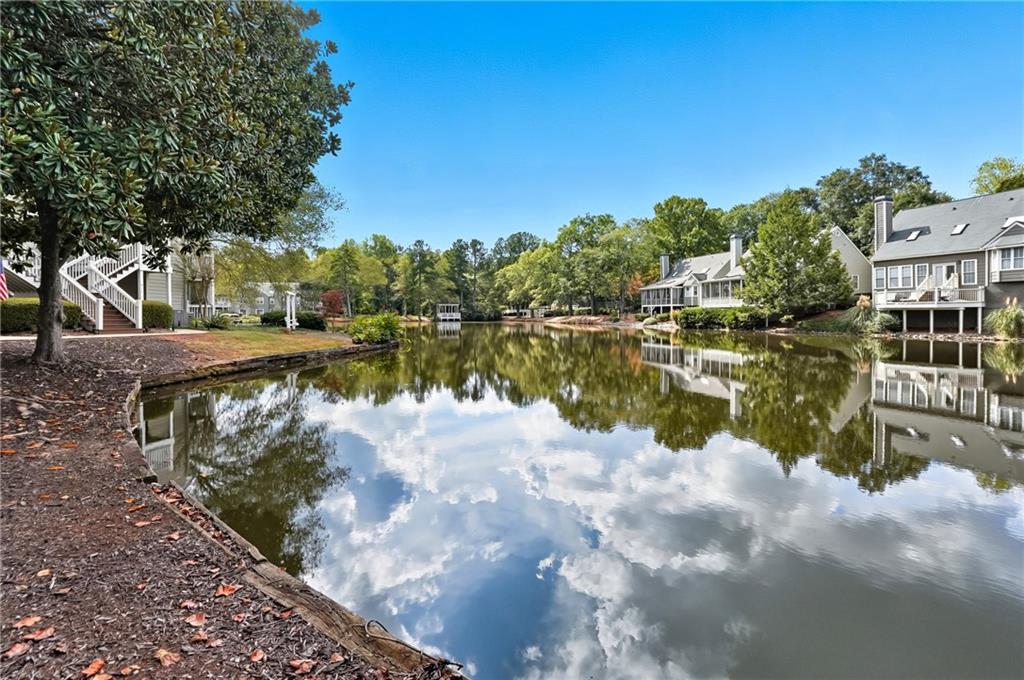 604 Mill Pond Road, Unit 604 Roswell, GA 30076 - Photo 27 of 28 a view of a lake with houses