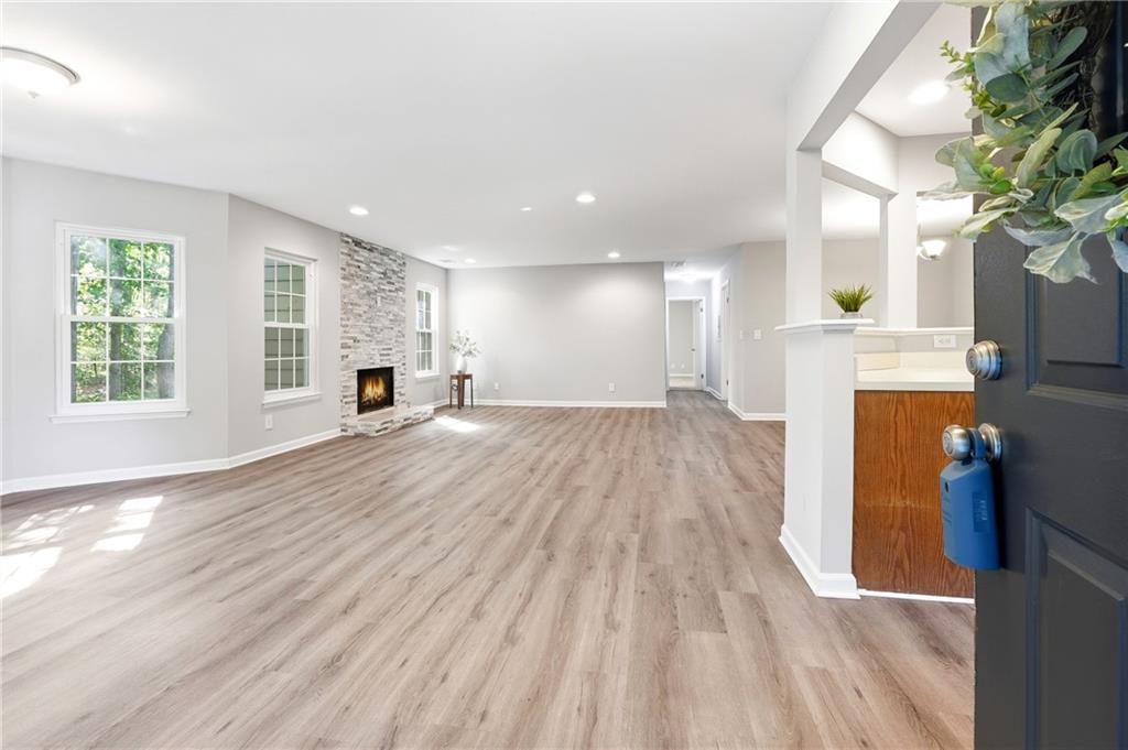 604 Mill Pond Road, Unit 604 Roswell, GA 30076 - Photo 3 of 28 a view of a living room and kitchen with wooden floor