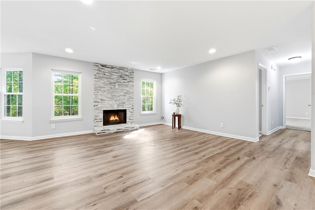 604 Mill Pond Road, Unit 604 Roswell, GA 30076 - Photo 5 of 28 a view of empty room with wooden floor and fireplace