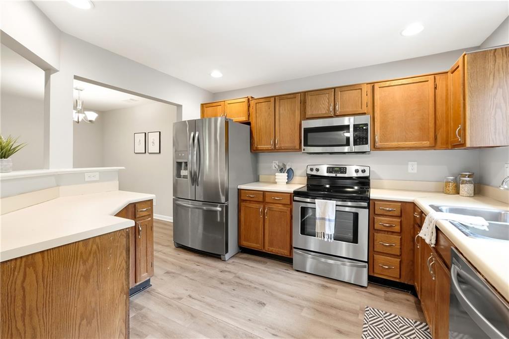 604 Mill Pond Road, Unit 604 Roswell, GA 30076 - Photo 8 of 28 a kitchen with a sink stove and refrigerator