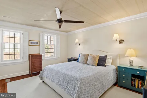 a bedroom with a large bed and a tv